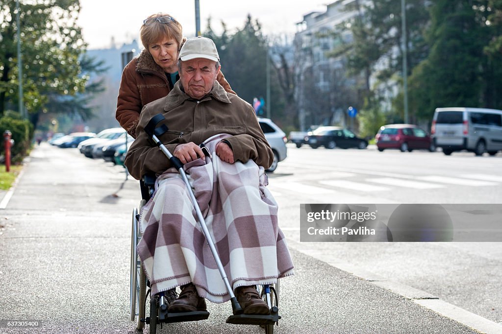 Senior Man in Wheelchair and Daughter in the City, Europe