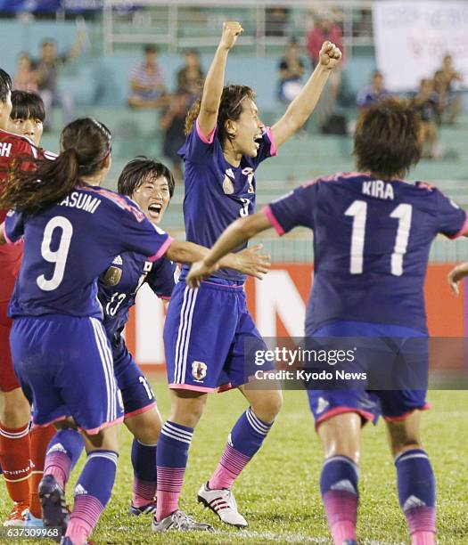 Vietnam - Defender Azusa Iwashimizu of Japan raises her fists after delivering a header in the dying seconds of extra time in a semifinal match...