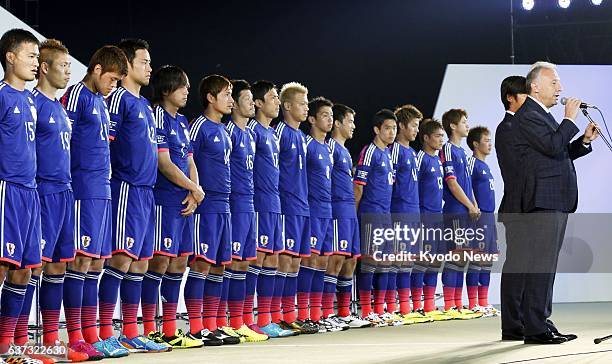 Japan - Japan players stand behind coach Alberto Zaccheroni speaking at Yoyogi National Gymnasium in Tokyo on May 25 during a send-off event before...