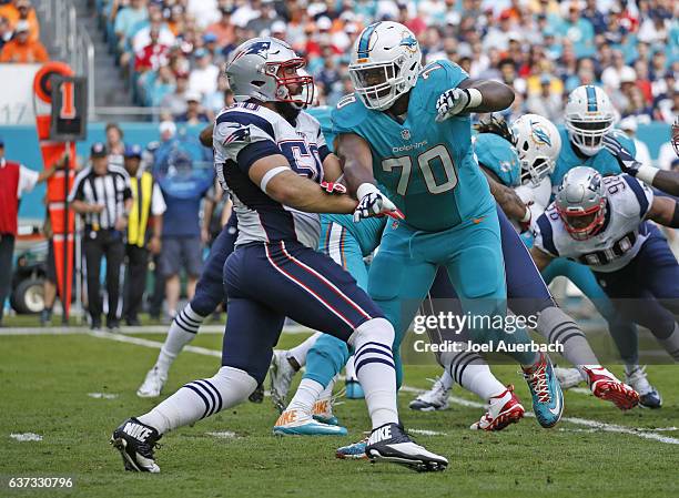 Ja'Wuan James of the Miami Dolphins defends against Rob Ninkovich of the New England Patriots on January 1, 2017 at Hard Rock Stadium in Miami...