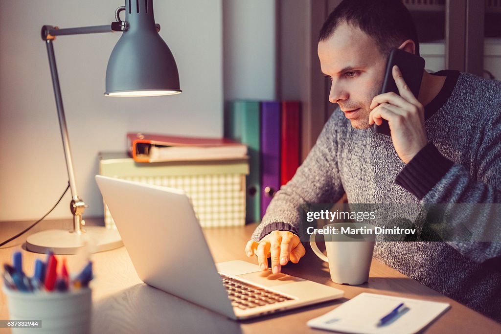 Man working on lap top late at night