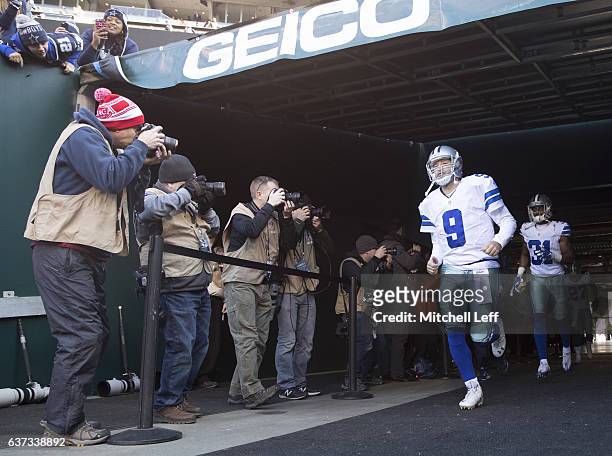 Tony Romo and Byron Jones of the Dallas Cowboys run onto the field prior to the game against the Philadelphia Eagles at Lincoln Financial Field on...
