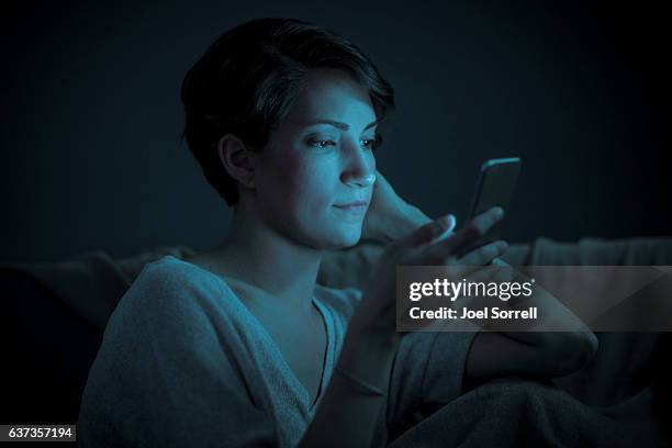 close up of a woman on her smart phone - glowing person stock pictures, royalty-free photos & images