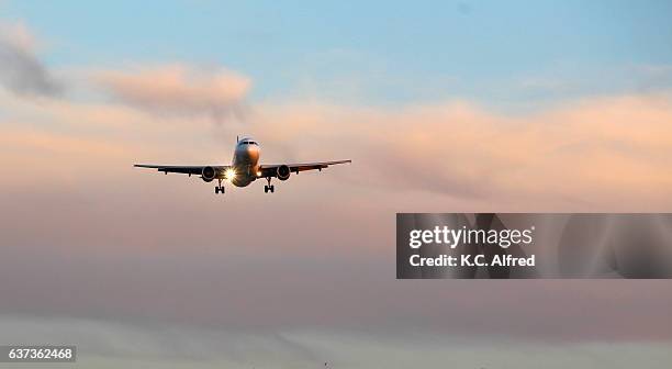 an airplane approaches an airport in san diego, california. - aircraft landing stock-fotos und bilder
