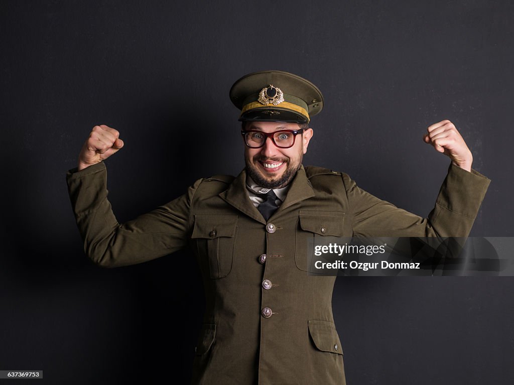 Goofy general in uniform flexing muscles