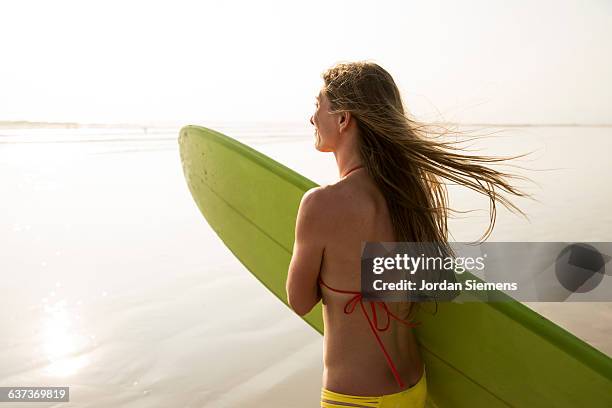 female walking with surfboards. - nosara costa rica stock pictures, royalty-free photos & images