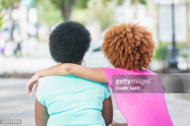 rear view, adult daughter with arm around mother - arm around friend back stock pictures, royalty-free photos & images