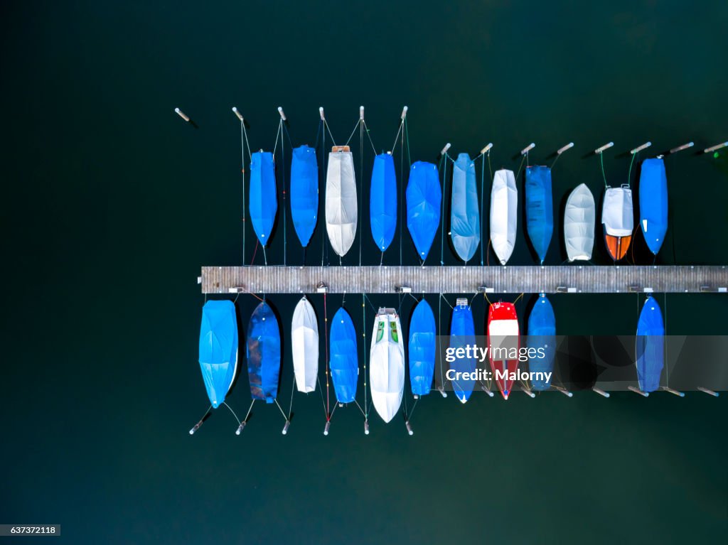 Boats moored at dock or jetty top view, view from above, aerial view