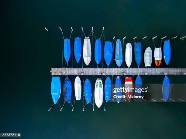 boats moored at dock or jetty top view, view from above, aerial view - chiemsee stockfoto's en -beelden