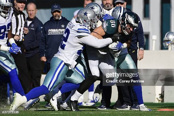 Zach Ertz of the Philadelphia Eagles is tackled by Andrew Gachkar of the Dallas Cowboys during the first quarter at Lincoln Financial Field on...