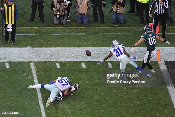 Darren Sproles of the Philadelphia Eagles is tackled by Damien Wilson of the Dallas Cowboys after failing to haul in a reception as Byron Jones of...