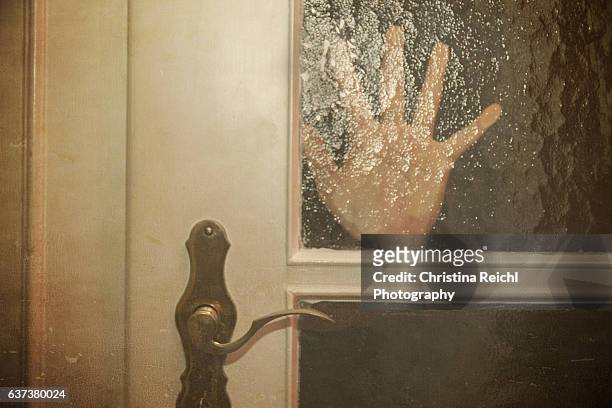 silhouette  of hand coming opening the door slowly - human trafficking 個照片及圖片檔