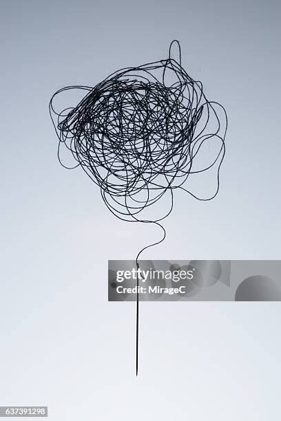 complexity of tagled thread and needle - confused white background stock-fotos und bilder