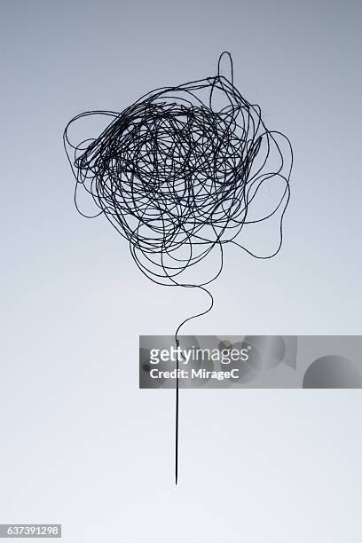 complexity of tagled thread and needle - tied up stock pictures, royalty-free photos & images