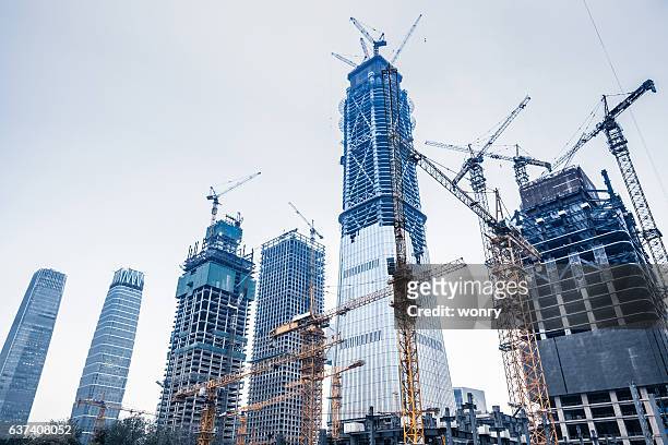 construction sites in beijing guomao - construction crane asia stock pictures, royalty-free photos & images