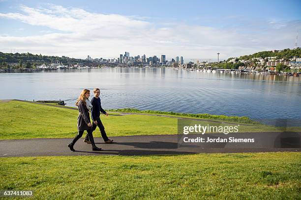 a couple walking a path - seattle city life stock pictures, royalty-free photos & images