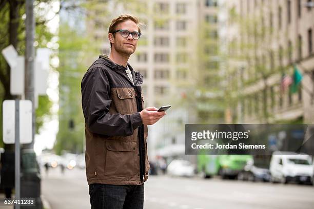 a male using a cell phone for transportation. - man side way looking stock pictures, royalty-free photos & images