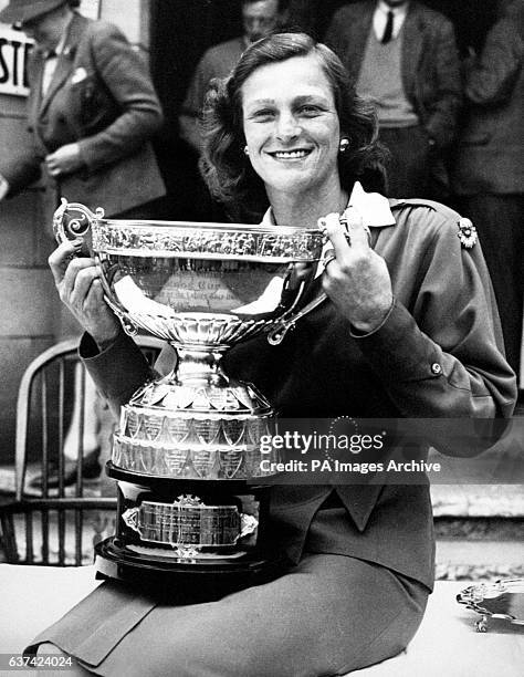 Mildred 'Babe' Zaharias poses with the trophy after winning the Ladies' Amateur Open Championship