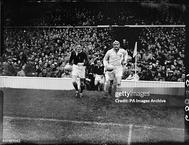 The two captains lead their teams out at Twickenham: Hennie Muller of South Africa and John Matthews of London Counties