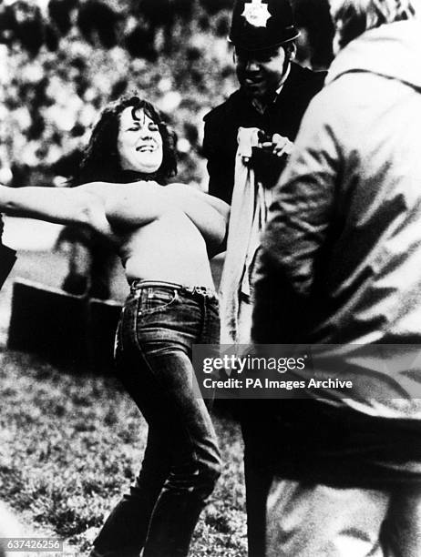 Erica Roe displays her credentials to an appreciative policeman after streaking across the Twickenham pitch