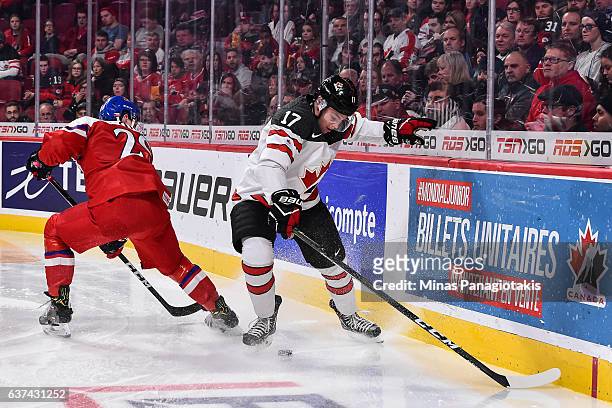 Tyson Jost of Team Canada defends the puck against Filip Hronek of Team Czech Republic during the 2017 IIHF World Junior Championship quarterfinal...