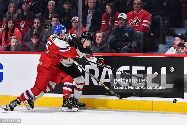 Tyson Jost of Team Canada and Kristian Reichel of Team Czech Republic battle for the puck against the boards during the 2017 IIHF World Junior...