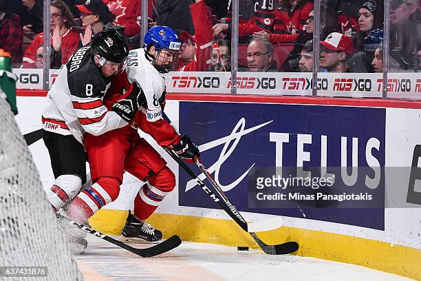 Dante Fabbro of Team Canada battles for the puck with Martin Necas of Team Czech Republic during the 2017 IIHF World Junior Championship quarterfinal...