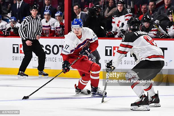 Lukas Jasek of Team Czech Republic skates the puck against Dante Fabbro of Team Canada during the 2017 IIHF World Junior Championship quarterfinal...