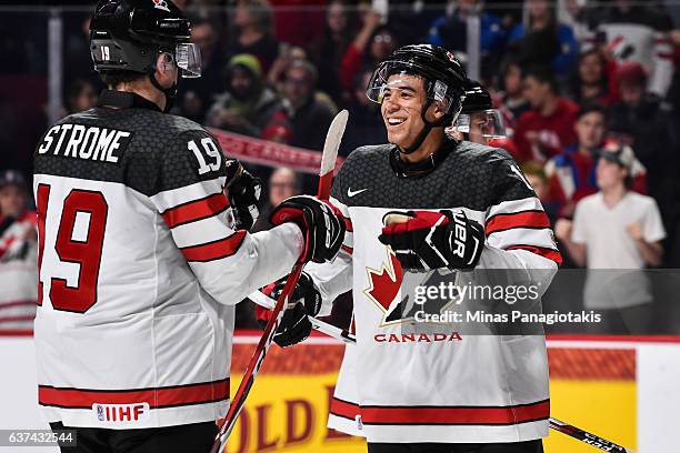 Mathieu Joseph of Team Canada reacts with teammate Dylan Strome after winning against Team Czech Republic during the 2017 IIHF World Junior...