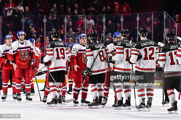 Members of Team Canada and Team Czech Republic shake hands during the 2017 IIHF World Junior Championship quarterfinal game against Team Czech...