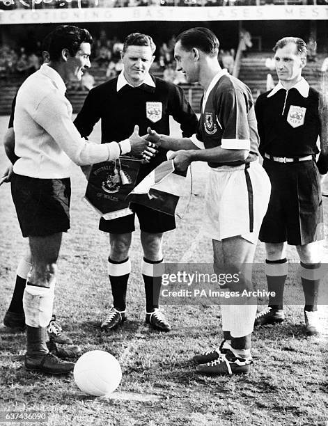 Mexico captain Antonio Carbajal shakes hands with Wales captain Dave Bowen , watched by referee Leo Lemesic