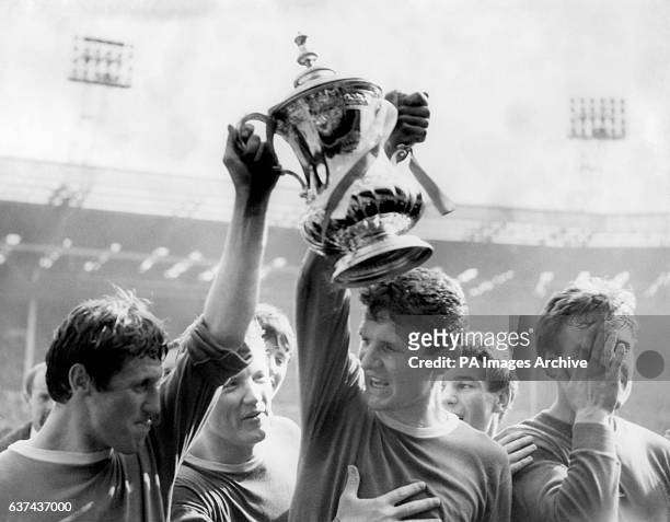 Everton's Brian Harris and Brian Labone celebrate with the FA Cup as teammate Jimmy Gabriel tries to get his hands on the much-coveted silverware