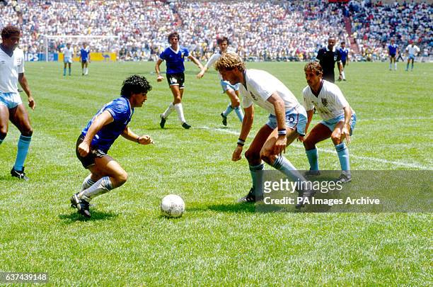 Argentina's Diego Maradona takes on England's Terry Butcher and Kenny Sansom.