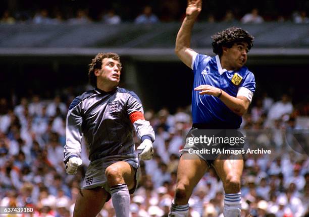 Argentina's Diego Maradona flies past England goalkeeper Peter Shilton after using his fist to score the opening goal, the infamous 'Hand of God' goal
