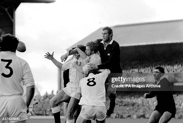 New Zealand's Andy Haden climbs above England's Roger Uttley and John Scott to win the line out ball