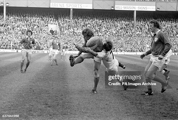 Ireland's Fergus Slattery kicks the ball away as England's Mike Rafter clatters into him