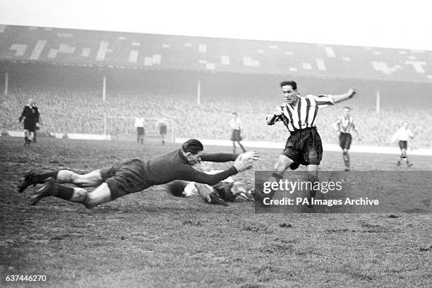 Tottenham Hotspur goalkeeper Ted Ditchburn dives at the feet of Newcastle United's George Robledo