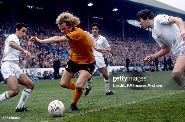 Wolverhampton Wanderers' Andy Gray tries to dribble past Tottenham Hotspur's Osvaldo Ardiles , Chris Hughton and Paul Miller