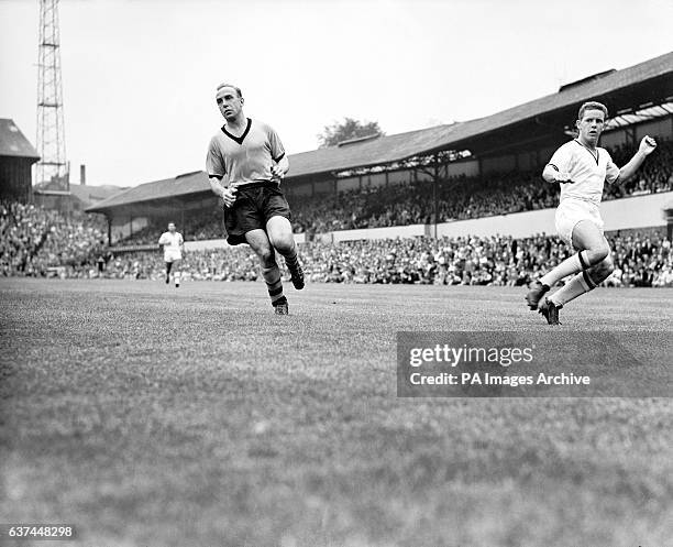Wolverhampton Wanderers reserves' Barry Stobart crosses the ball beyond Billy Wright , making his final appearance in the old gold and black