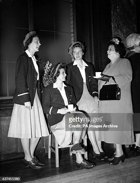 Mrs JA Beasley , the Australian High Commissioner's wife, talks to Australian athletes Judy Canty, June Mason and Shirley Strickland.