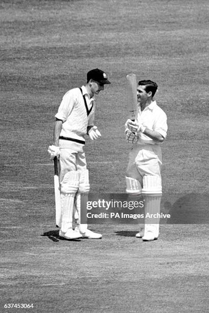 Australia's Bill Lawry checks on the condition of teammate Neil Harvey's bat