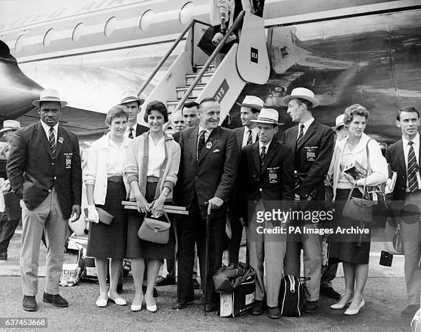 Some of the British medallists pictured upon their arrival at London Airport: weightlifter Louis Martin , high jumper Dorothy Shirley , 100m runner...