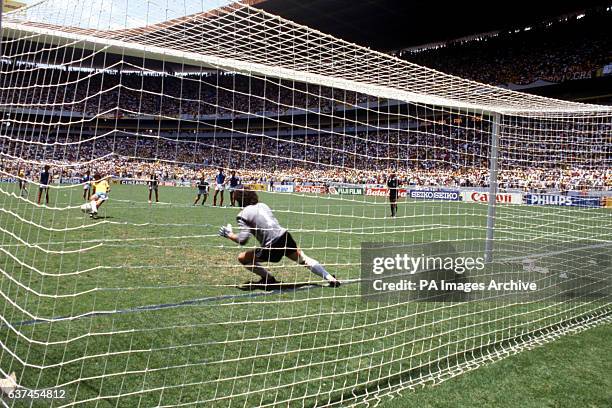 France goalkeeper Joel Bats dives the right way to save a penalty from Brazil's Zico , who had come on as a substitute only four minutes earlier