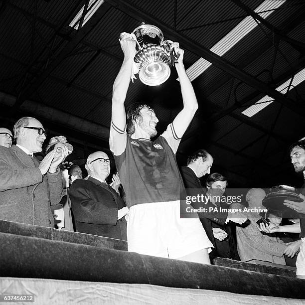 West Ham United captain Billy Bonds holds the FA Cup aloft
