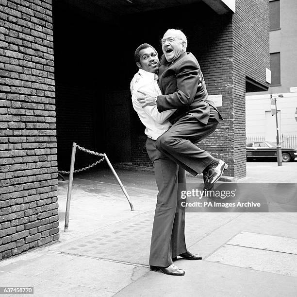 American heavyweight boxer Ken Norton gives promoter Jack Solomons a lift