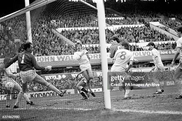 Manchester United's Bryan Robson fires the opening goal past Liverpool goalkeeper Bruce Grobbelaar , watched by teammate Mark Hughes and Liverpool's...