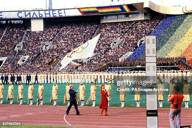 Dick Palmer, Great Britain's Chef de Mission and sole representative in the opening ceremony, carries the Olympic flag around the Olympic Stadium