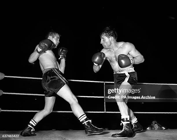 Freddie Gilroy of Belfast backs away from Rene Libeer of France during the boxing match at the Empire Pool.