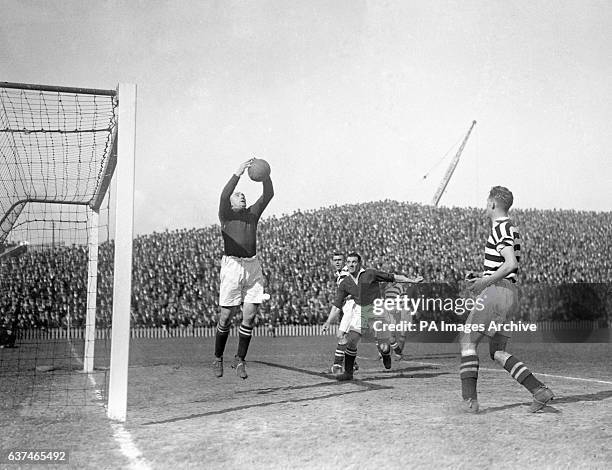 Manchester United goalkeeper John Hacking claims the ball.