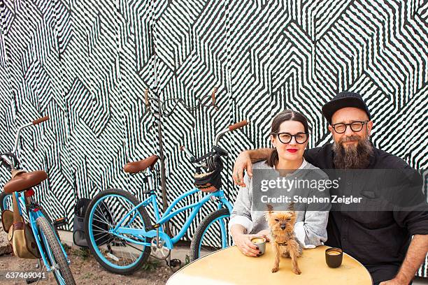 couple at an outdoor cafe - dog drinking stock-fotos und bilder